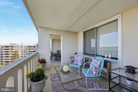 a living room with furniture and flowers