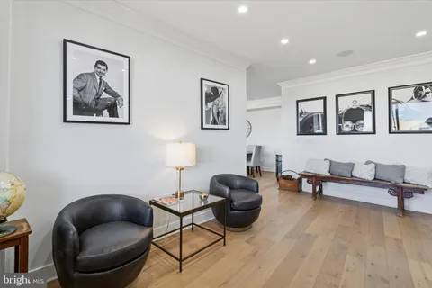 a work room with furniture and paintings on the wall