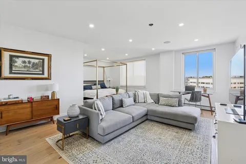a living room with furniture and kitchen view