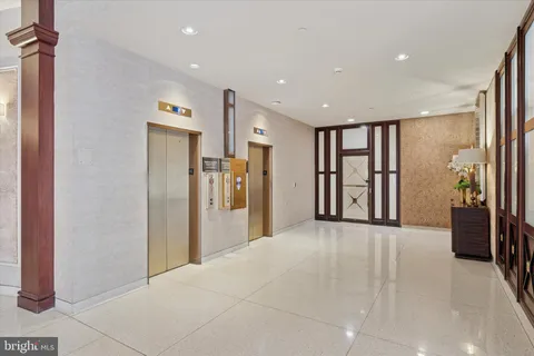 a view of a hallway with wooden shelves
