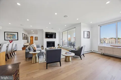 a living room with fireplace furniture and a wooden floor