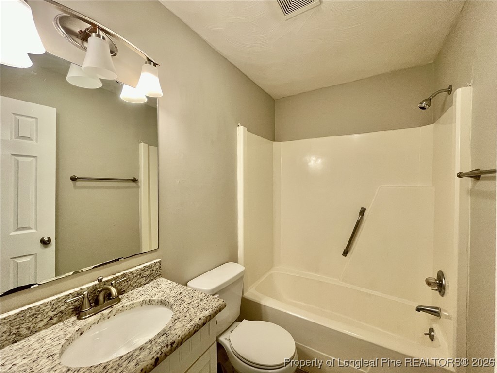 820 Anarine Road, Unit A Fayetteville, NC 28303 - Photo 13 of 22 a bathroom with a granite countertop sink toilet and shower