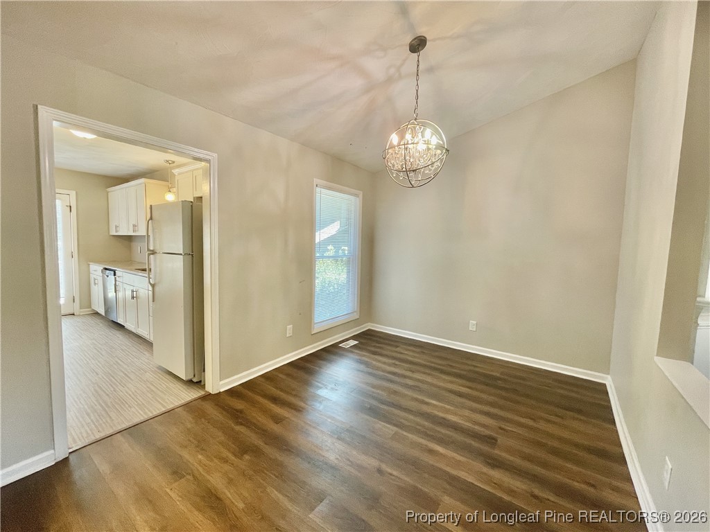 820 Anarine Road, Unit A Fayetteville, NC 28303 - Photo 4 of 22 a view of a hallway with wooden floor and a chandelier