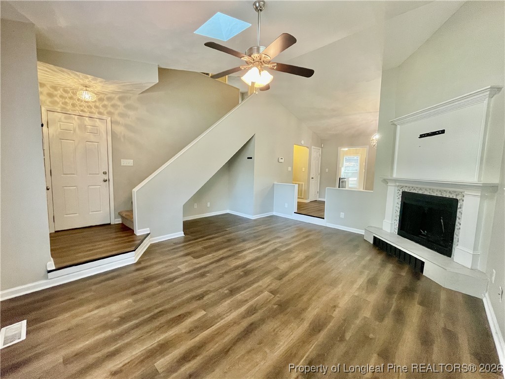 820 Anarine Road, Unit A Fayetteville, NC 28303 - Photo 5 of 22 a view of an empty room with chandelier fan and wooden floor