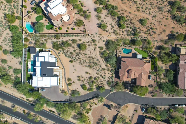 a aerial view of a house with a yard and lake view