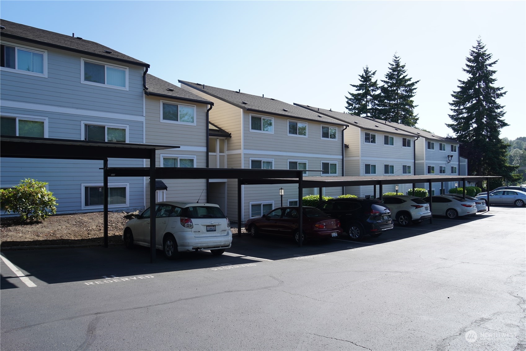 15210 Macadam Road South, Unit D205 Tukwila, WA 98188 - Photo 2 of 11 a car parked in front of a white building