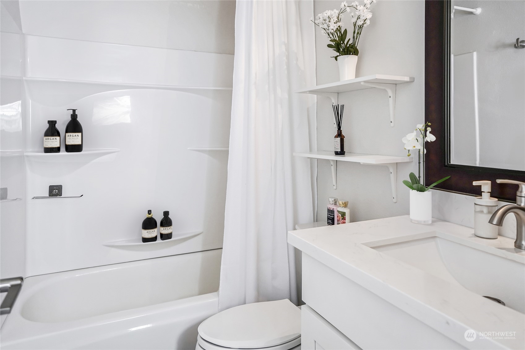 15210 Macadam Road South, Unit D205 Tukwila, WA 98188 - Photo 7 of 11 a bathroom with a sink a toilet and vanity