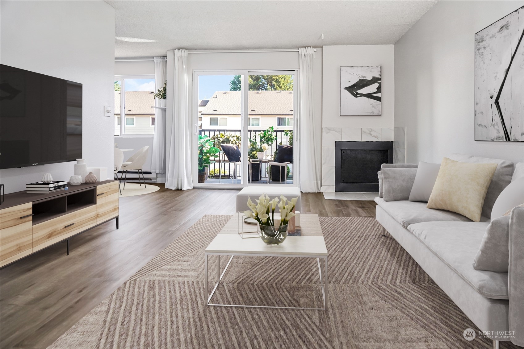 15210 Macadam Road South, Unit D205 Tukwila, WA 98188 - Photo 9 of 11 a living room with furniture a flat screen tv and a fireplace
