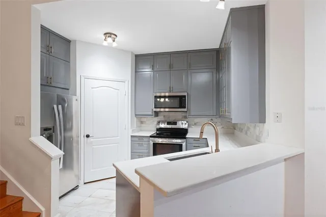 a kitchen with a sink cabinets and wooden floor