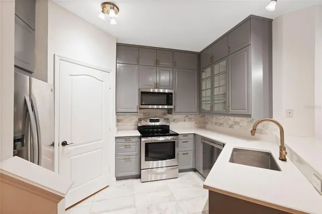 a view of an empty room with closet and a window