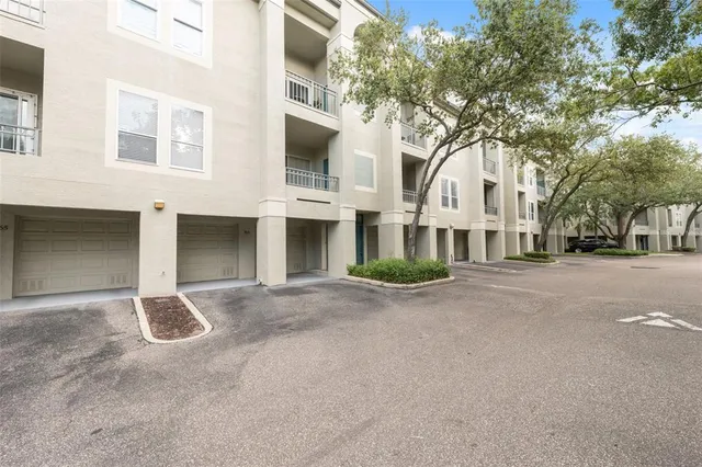 a front view of a house with yard and parking