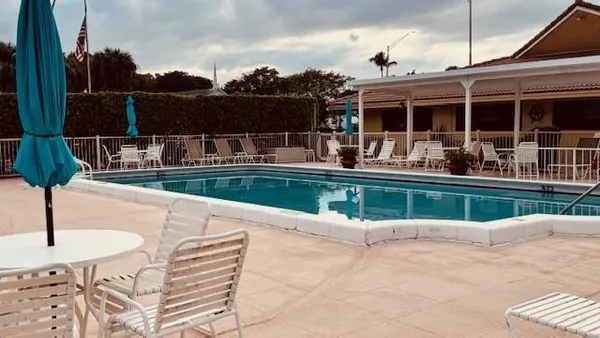a swimming pool with outdoor seating