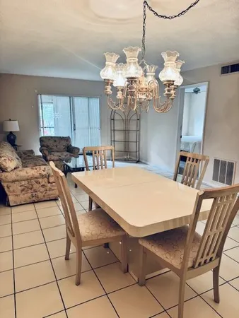 a dining room with furniture and chandelier