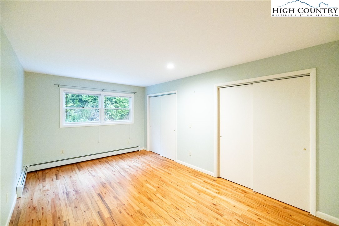 2530 Bear Wallow Road Lansing, NC 28643 - Photo 30 of 48 an empty room with wooden floor and windows