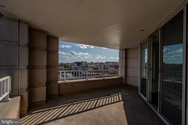 a view of a hallway with wooden floor and closet