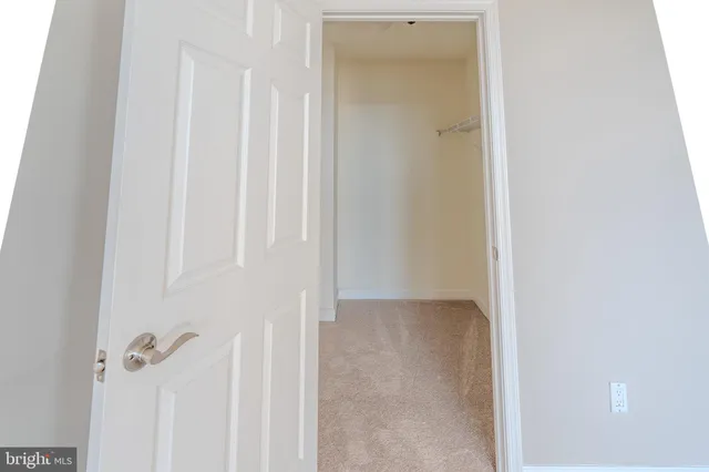 a view of an empty room and closet area