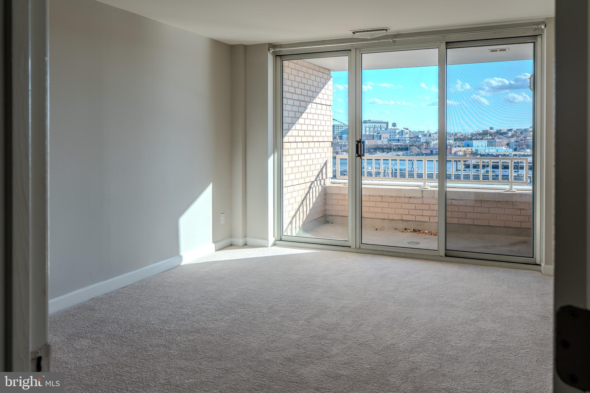 100 Harborview Drive, Unit 302 Baltimore, MD 21230 - Photo 3 of 48 a view of empty room with floor to ceiling window