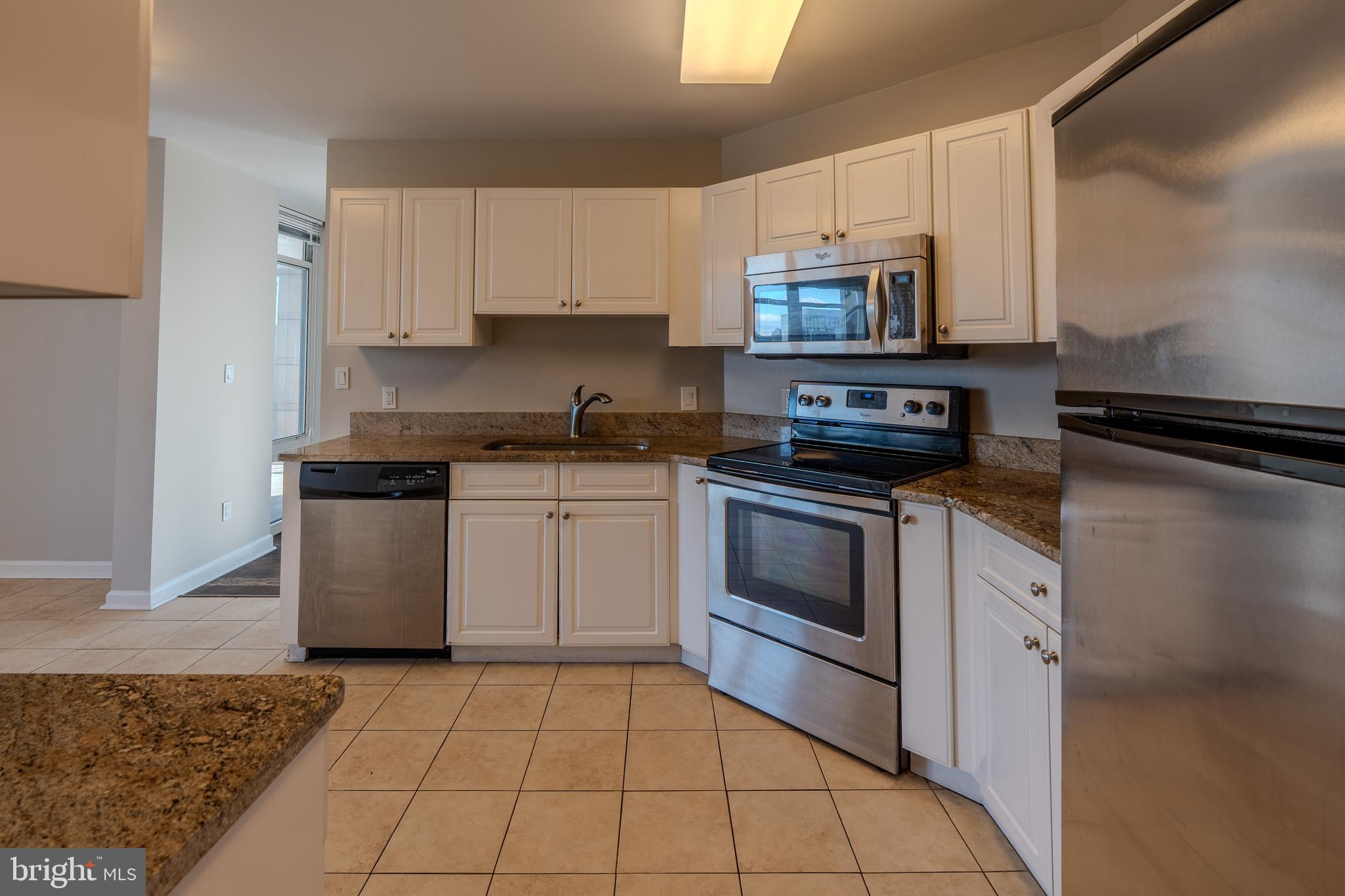 100 Harborview Drive, Unit 302 Baltimore, MD 21230 - Photo 33 of 48 a kitchen with a sink stove and cabinets