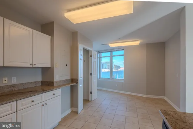 a kitchen with a refrigerator sink and cabinets