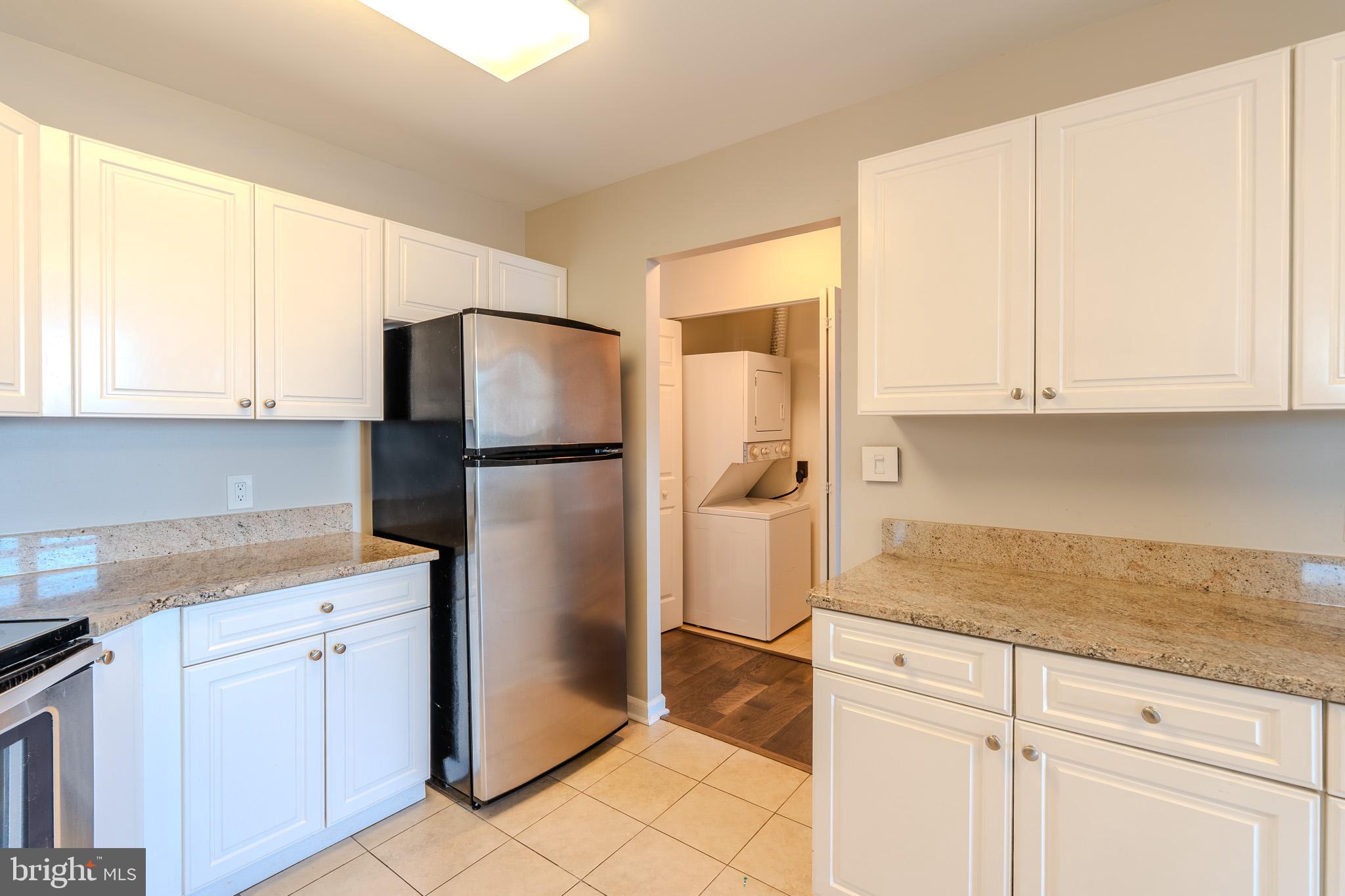 100 Harborview Drive, Unit 302 Baltimore, MD 21230 - Photo 36 of 48 a kitchen with a refrigerator sink and cabinets