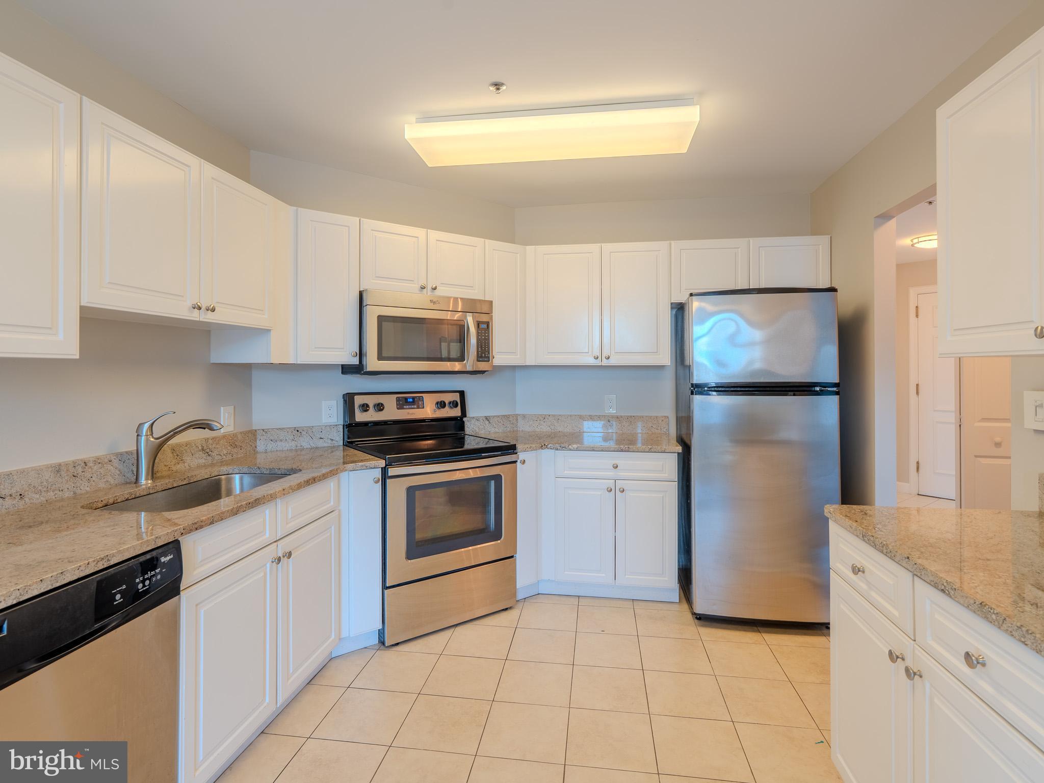 100 Harborview Drive, Unit 302 Baltimore, MD 21230 - Photo 37 of 48 a kitchen with a sink a stove and refrigerator