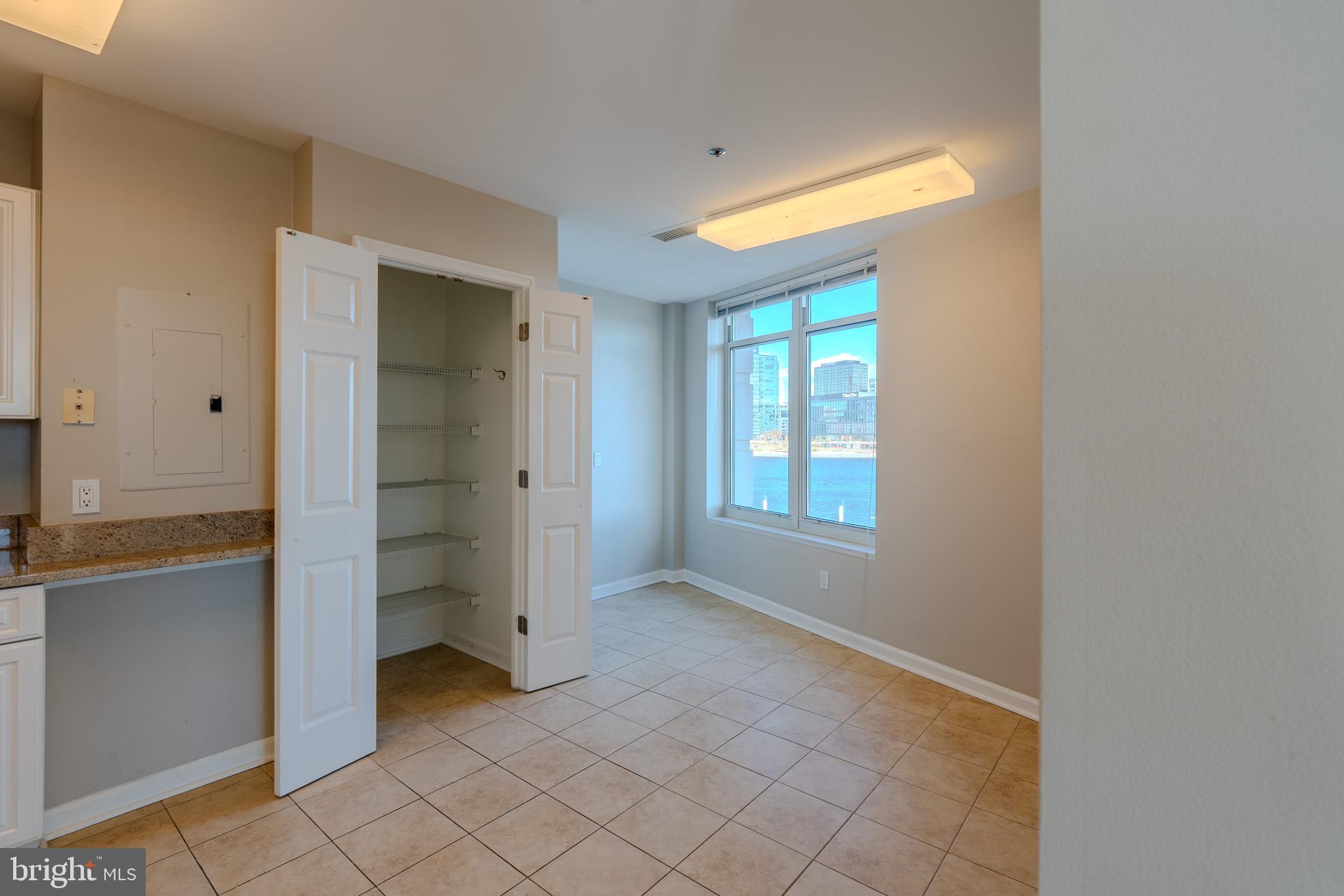 100 Harborview Drive, Unit 302 Baltimore, MD 21230 - Photo 4 of 48 an empty room with windows and closet