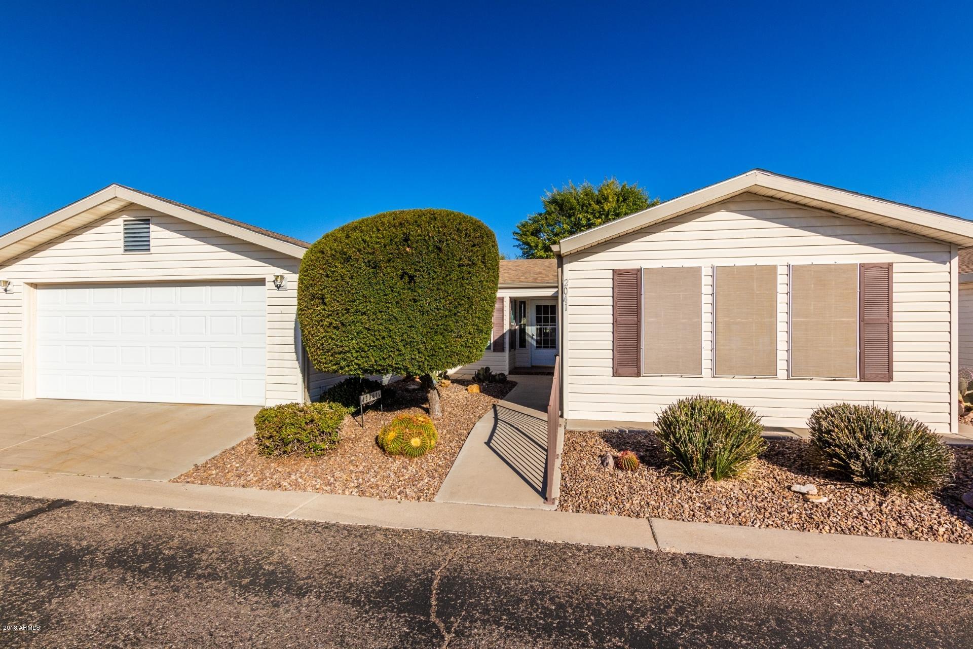 3301 South Goldfield Road, Unit 2041 Apache Junction, AZ 85119 - Photo 1 of 26 a front view of a house with a yard
