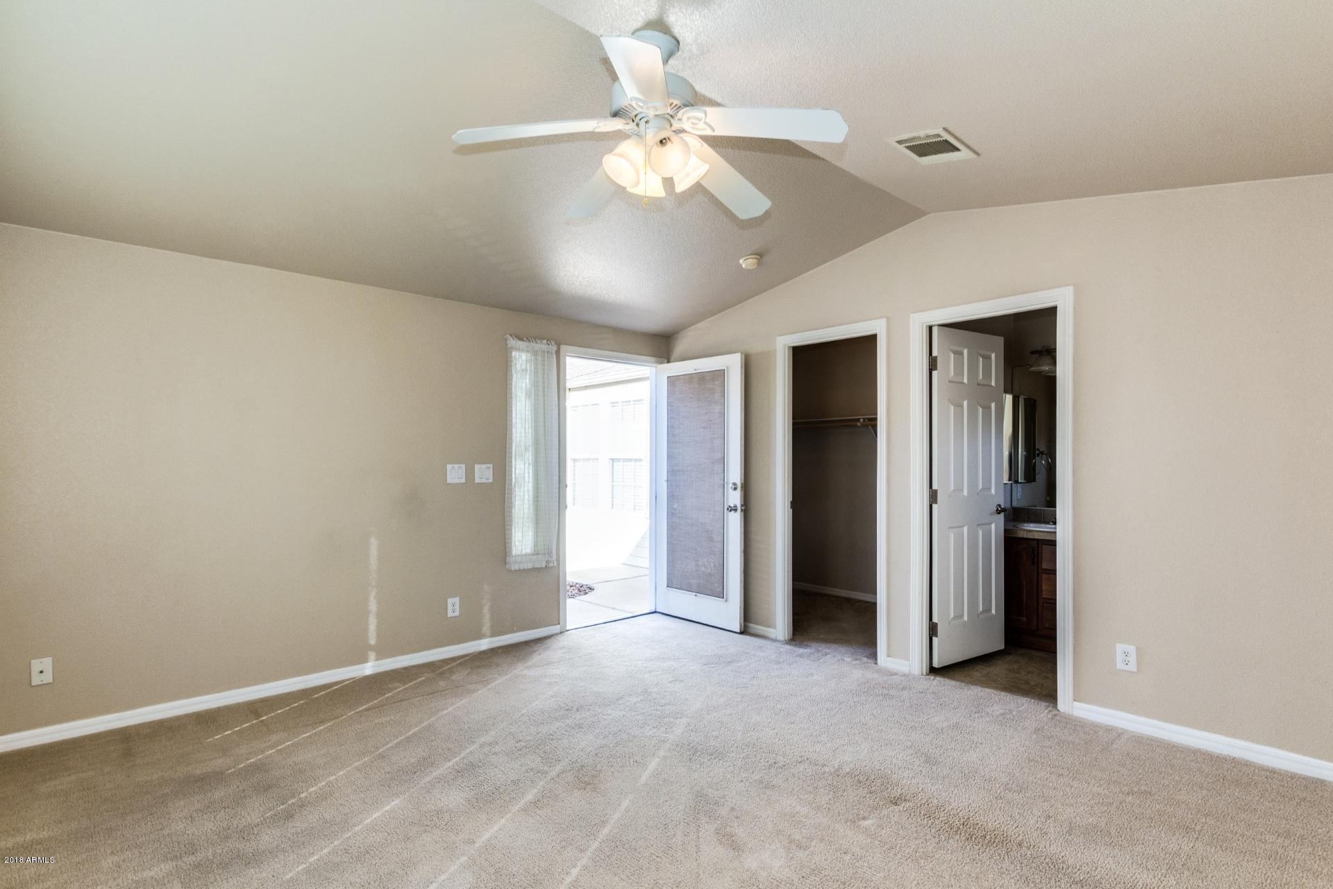 3301 South Goldfield Road, Unit 2041 Apache Junction, AZ 85119 - Photo 17 of 26 an empty room with fan and entrance