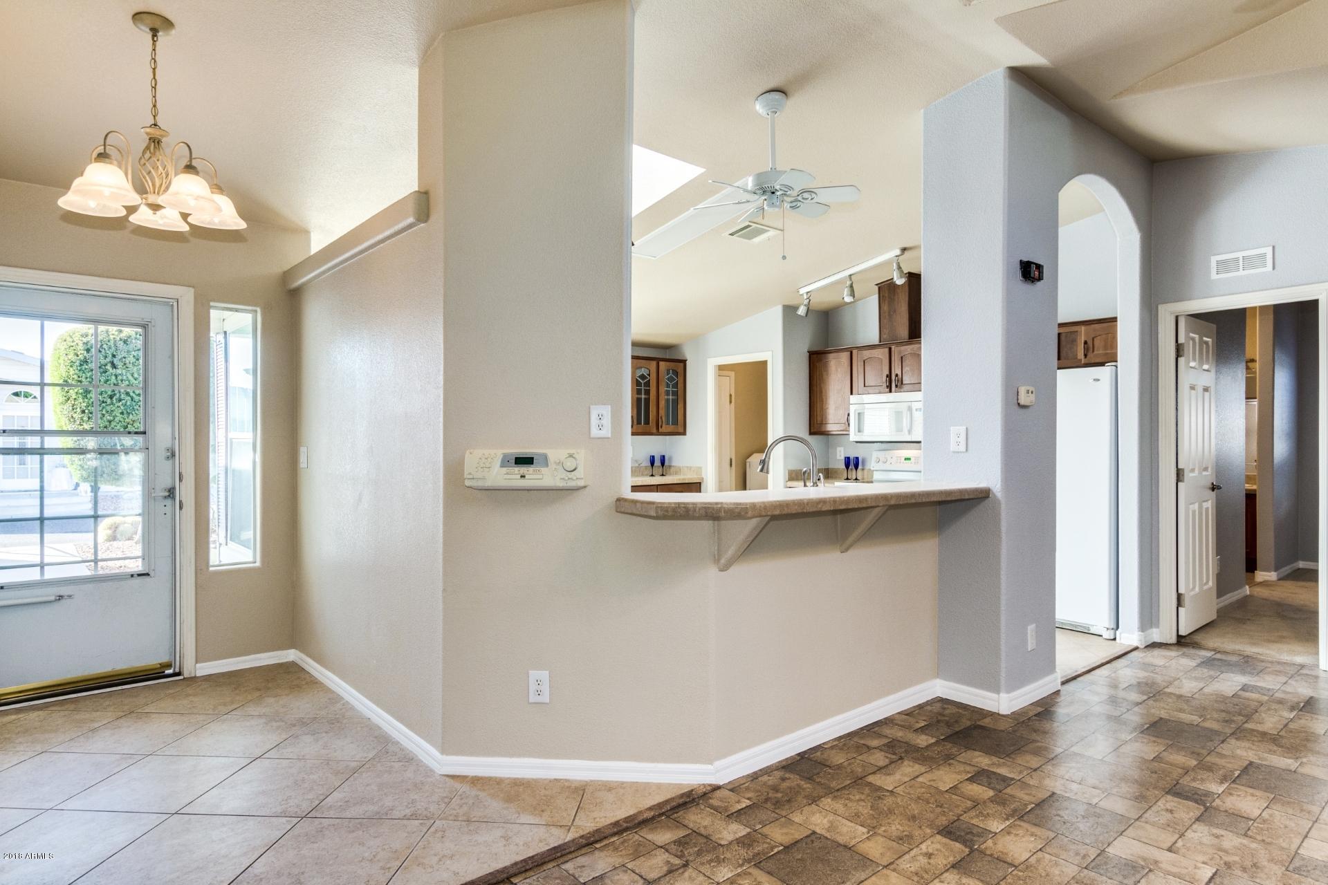 3301 South Goldfield Road, Unit 2041 Apache Junction, AZ 85119 - Photo 3 of 26 a view of an entryway with chandelier