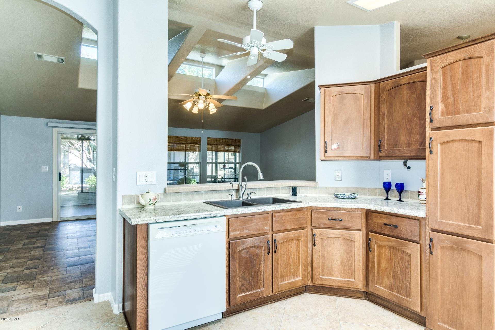 3301 South Goldfield Road, Unit 2041 Apache Junction, AZ 85119 - Photo 10 of 26 a kitchen with cabinets a sink and appliances