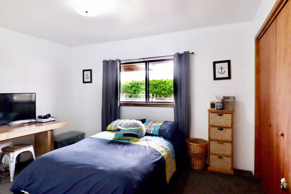 17-212 Volcano Road Keaau, HI 96749 - Photo 11 of 24 a bedroom with a bed and a window