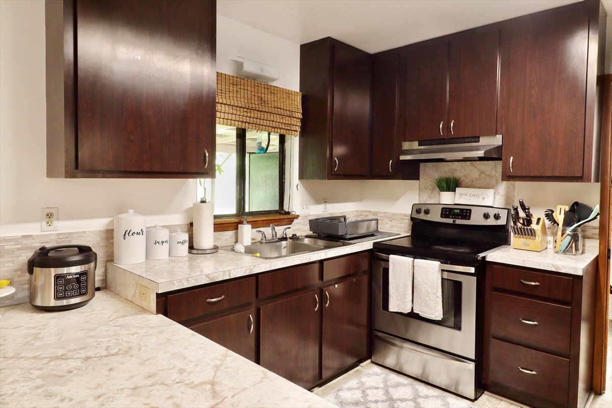 17-212 Volcano Road Keaau, HI 96749 - Photo 5 of 24 a kitchen with a sink and cabinets