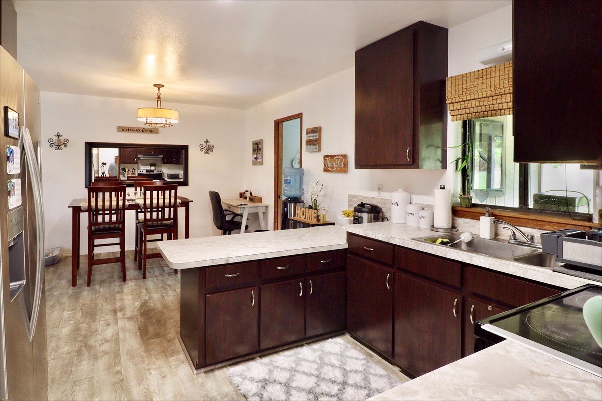 17-212 Volcano Road Keaau, HI 96749 - Photo 6 of 24 a kitchen with a sink dining table and chairs