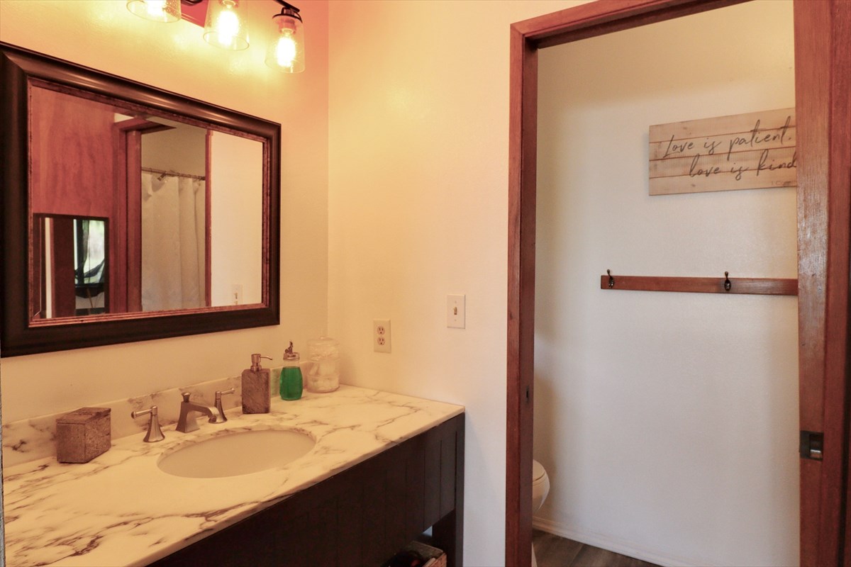 17-212 Volcano Road Keaau, HI 96749 - Photo 9 of 24 a bathroom with a sink vanity and a mirror