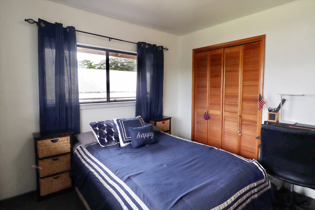 17-212 Volcano Road Keaau, HI 96749 - Photo 10 of 24 a bedroom with a bed and a window