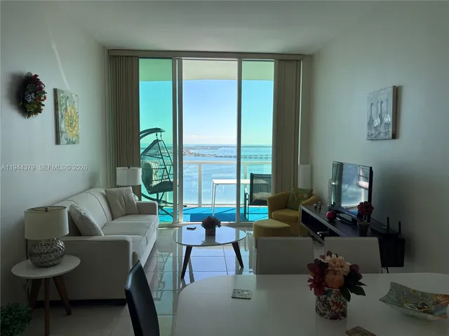 a living room with furniture and a large window