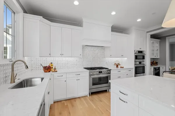 a kitchen with granite countertop a sink stainless steel appliances and cabinets