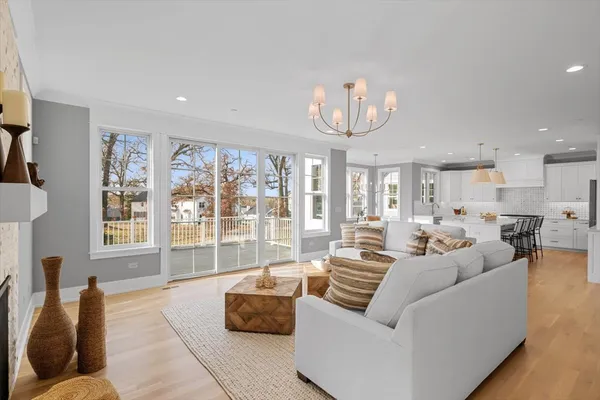 a living room with furniture and a chandelier