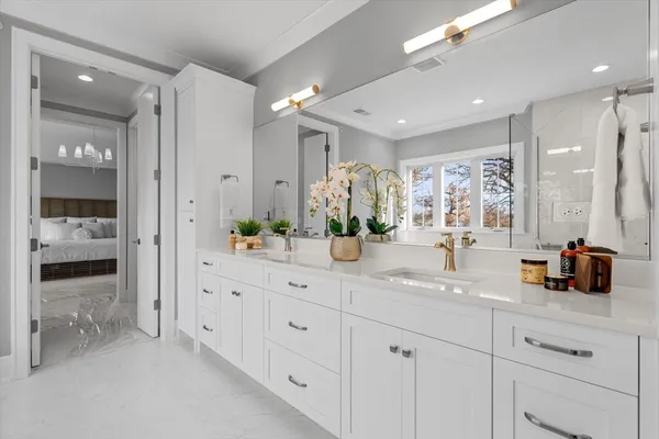 a spacious bathroom with double sink and a mirror