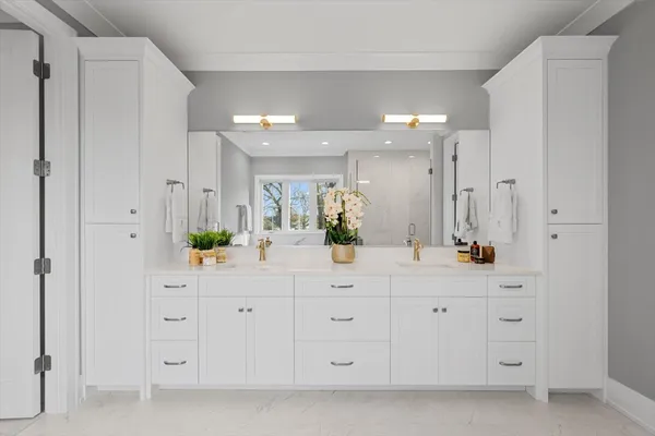 a bathroom with a double vanity sink and a mirror