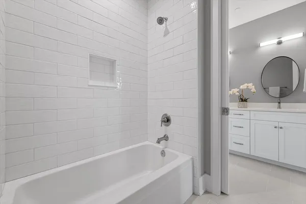a bathroom with a sink a bathtub and a window