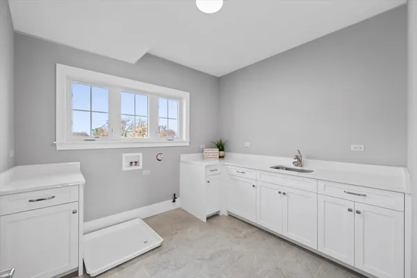a room with a sink and cabinets