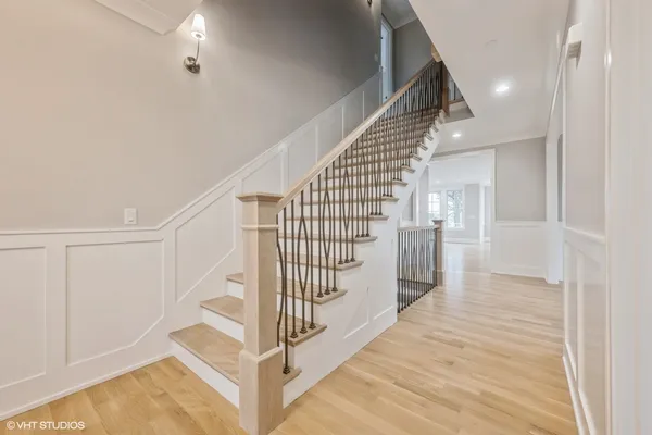 a view of entryway and hall with wooden floor