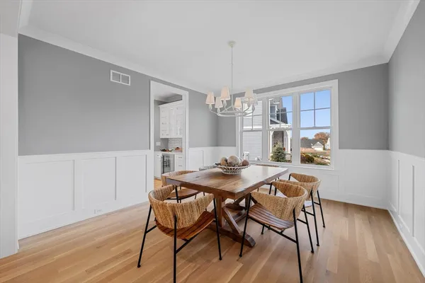 a view of a dining room with furniture wooden floor and chandelier