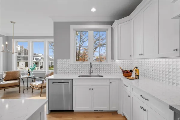 a kitchen with stainless steel appliances granite countertop a sink stove and cabinets