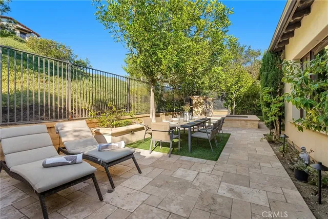 a view of a patio with furniture and a fire pit