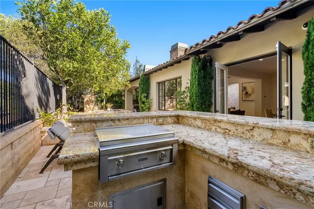 a view of a kitchen with a sink and dishwasher a kitchen island with wooden cabinets