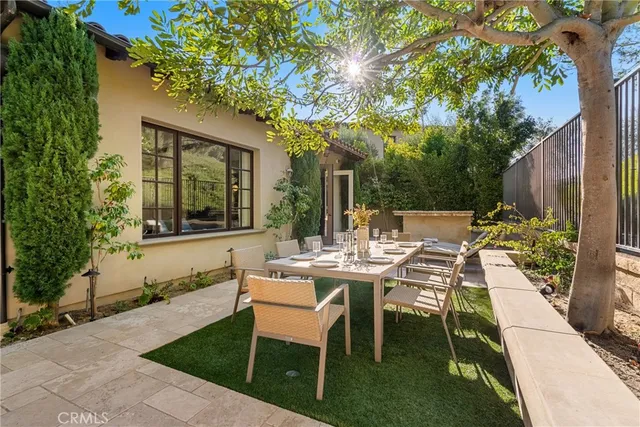 a view of a patio with table and chairs and potted plants