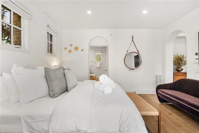 a bedroom with a large bed and a chandelier