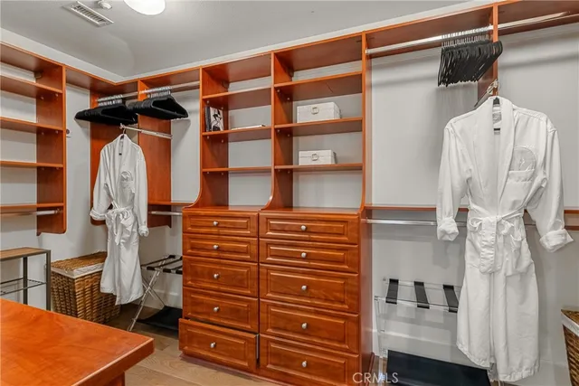 a view of walk in closet and bedroom